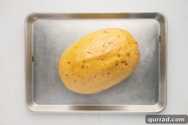 whole roasted spaghetti squash on baking sheet