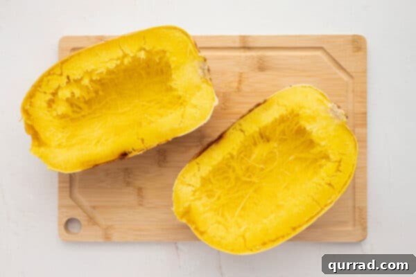 2 roasted spaghetti squash halves with seeds and pulp removed