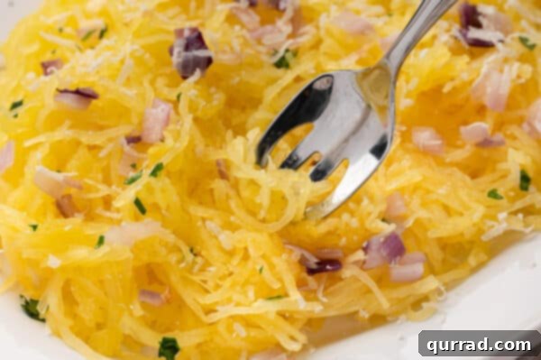 close up cooked spaghetti squash strands swirled on fork