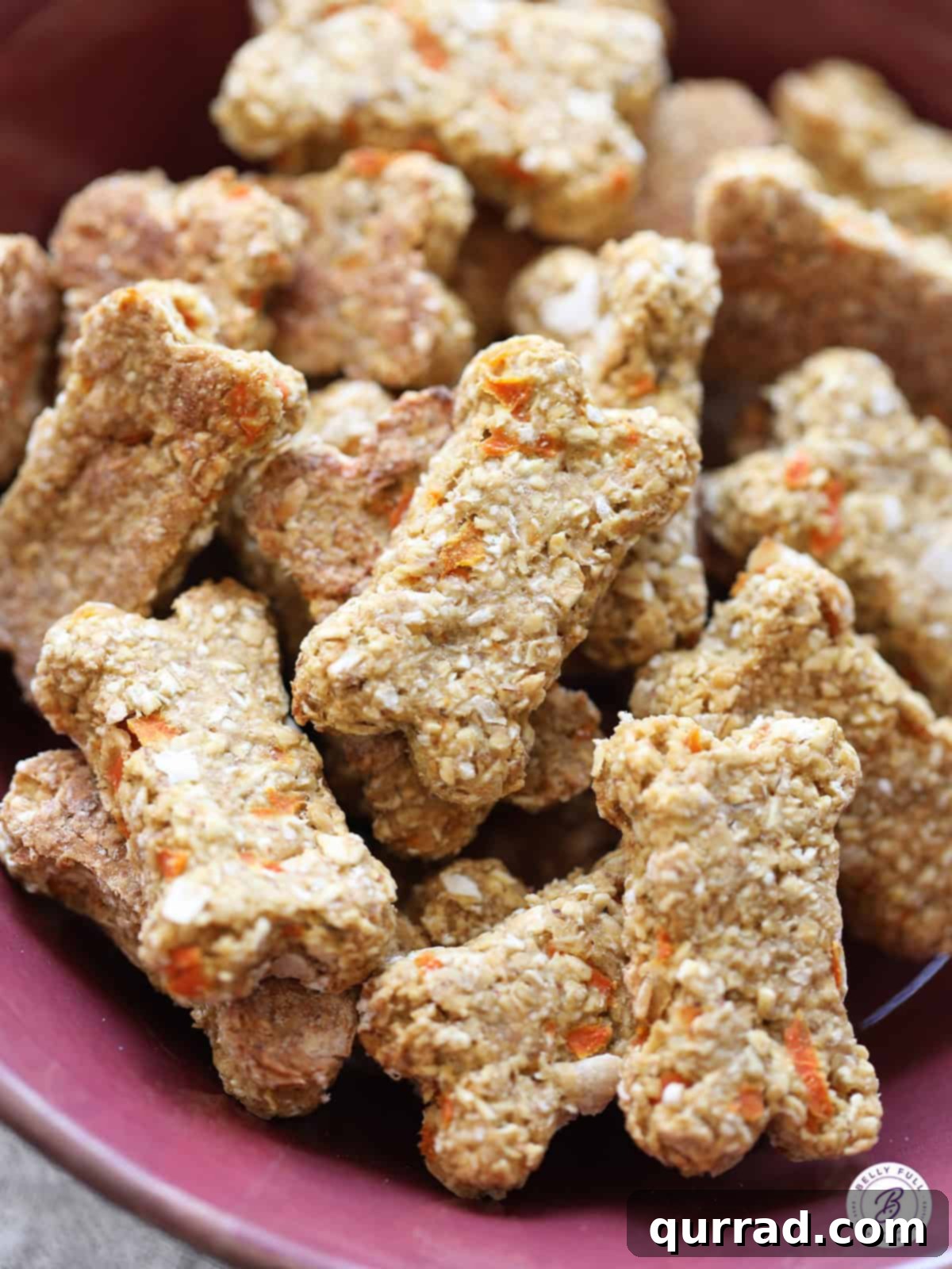 Paw-some Carrot Cake Treats 2 A bowl overflowing with freshly baked, bone-shaped carrot cake dog treats, ready for your furry friend.