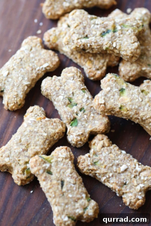 Homemade dog biscuits with banana and zucchini ingredients displayed