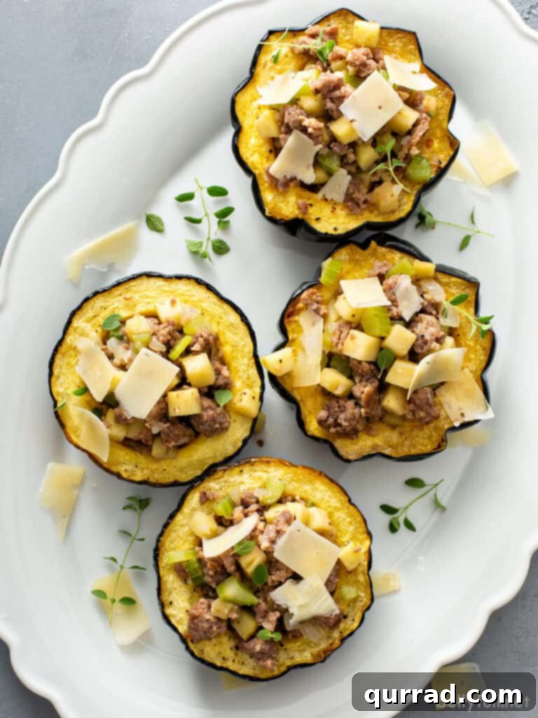 Autumn Sausage Stuffed Squash Boats 5 overhead 4 stuffed acorn squash halves on white plate