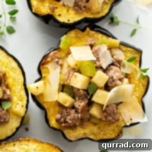 sausage and apple stuffed acorn squash with shaved Parmesan