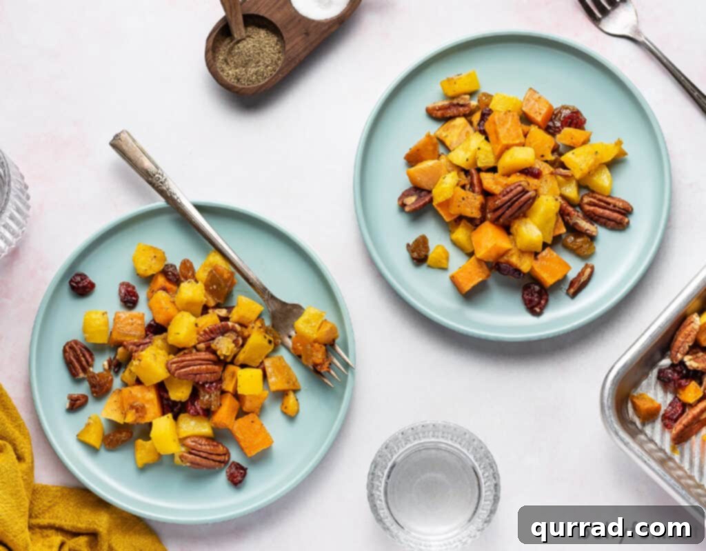 Sweet and Savory Autumn Roast with Cranberries and Pecans 4 Two plates with generous servings of roasted winter squash, cranberries, and pecans, ready for a fall meal.