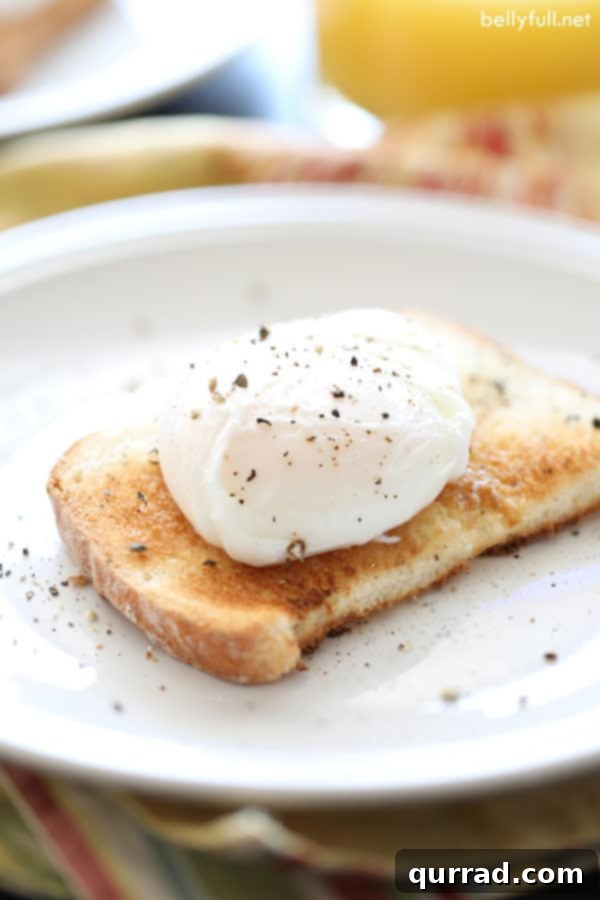Two perfectly poached eggs glistening on a slice of rustic toast, ready to be enjoyed