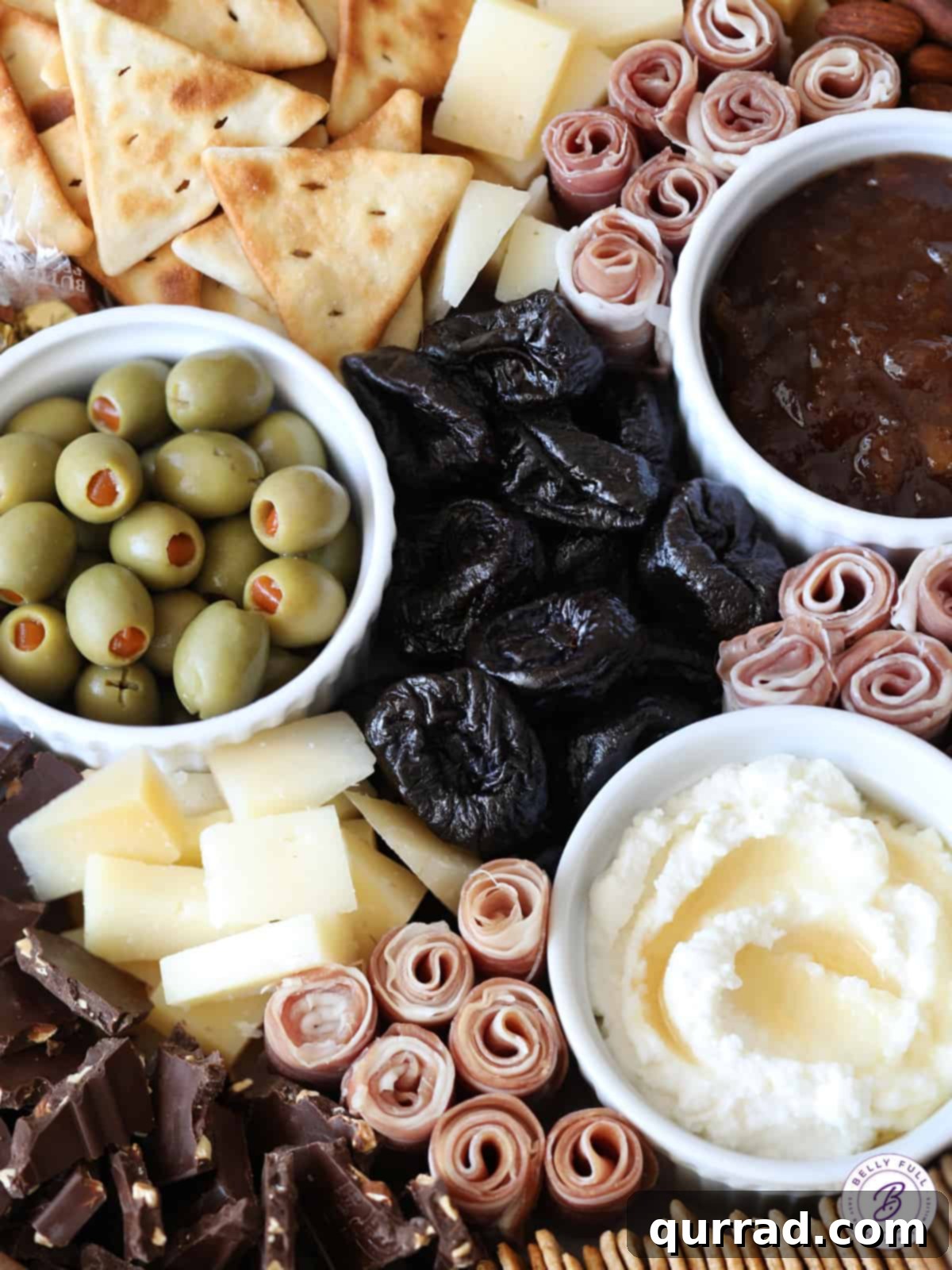 Overhead close-up shot of a vibrant Fall-themed charcuterie board, highlighting the diverse array of ingredients and their artful arrangement