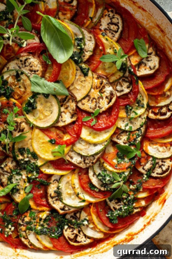 Provencal Ratatouille Delight 5 Close-up overhead view of roasted garden vegetables arranged in a spiral pattern in a pan