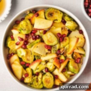 Sweet & Savory Roasted Brussels with Apples 6 roasted brussels sprouts with apples and pomegranate seeds in bowl