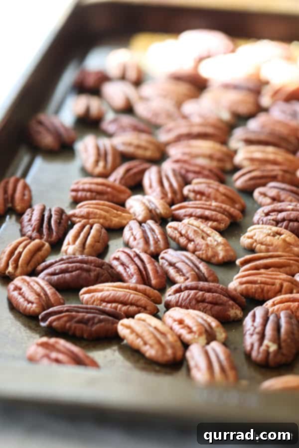 toasted pecan halves on baking sheet