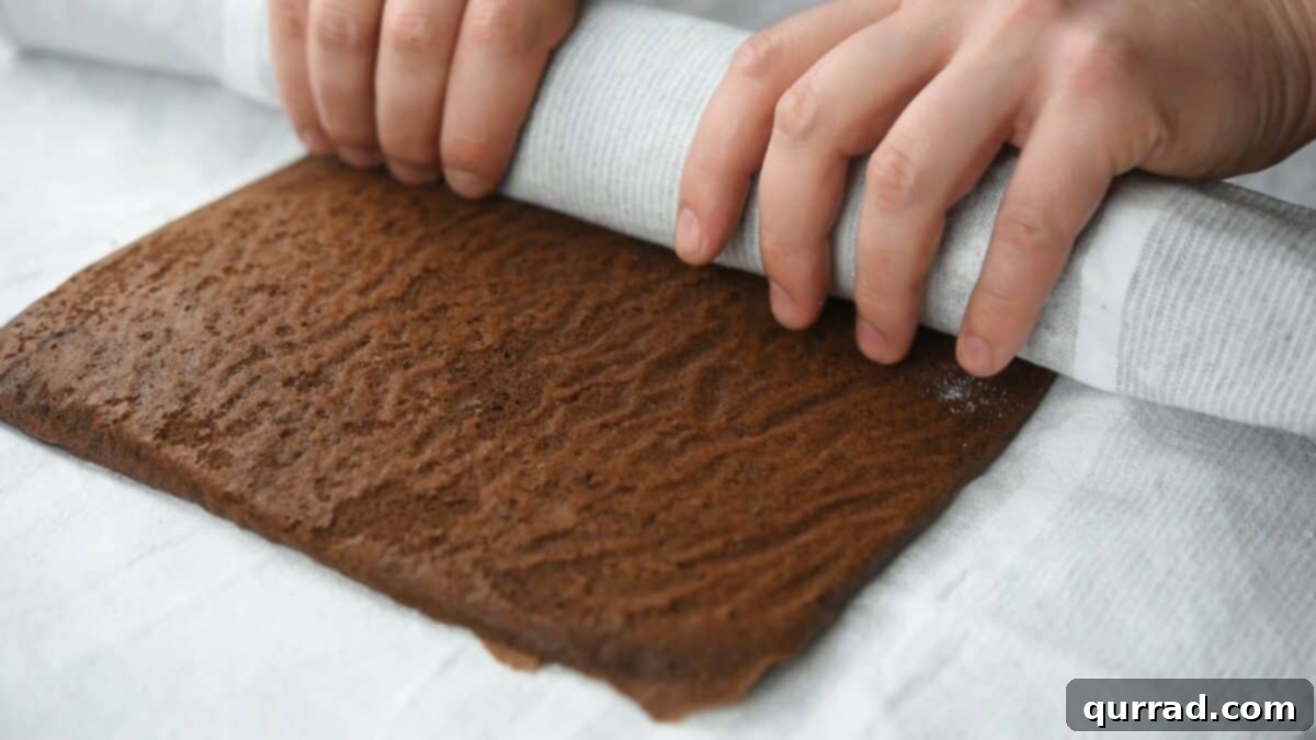 Decadent Chocolate Log 9 Rolling the cake in a dish towel.