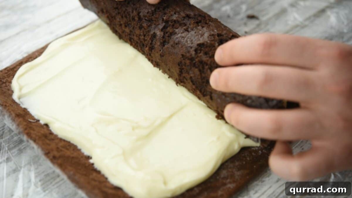 Decadent Chocolate Log 13 Rerolling the cake.