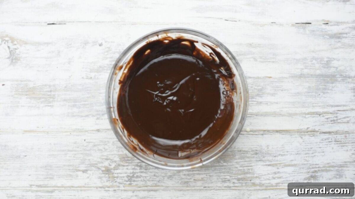 Decadent Chocolate Log 14 Chocolate ganache in a glass bowl.