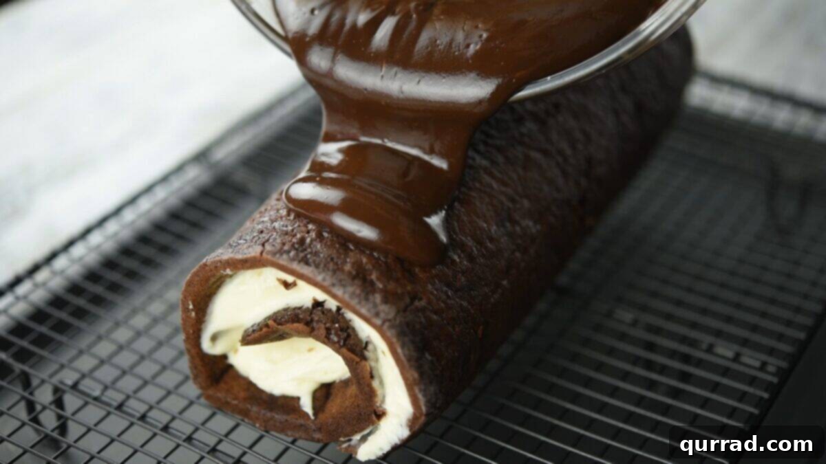 Decadent Chocolate Log 15 Pouring the ganache over the cake.