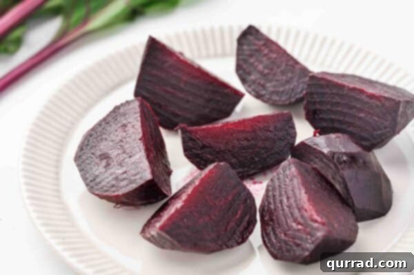 roasted beets cut into wedges on a plate, garnished and ready to be served