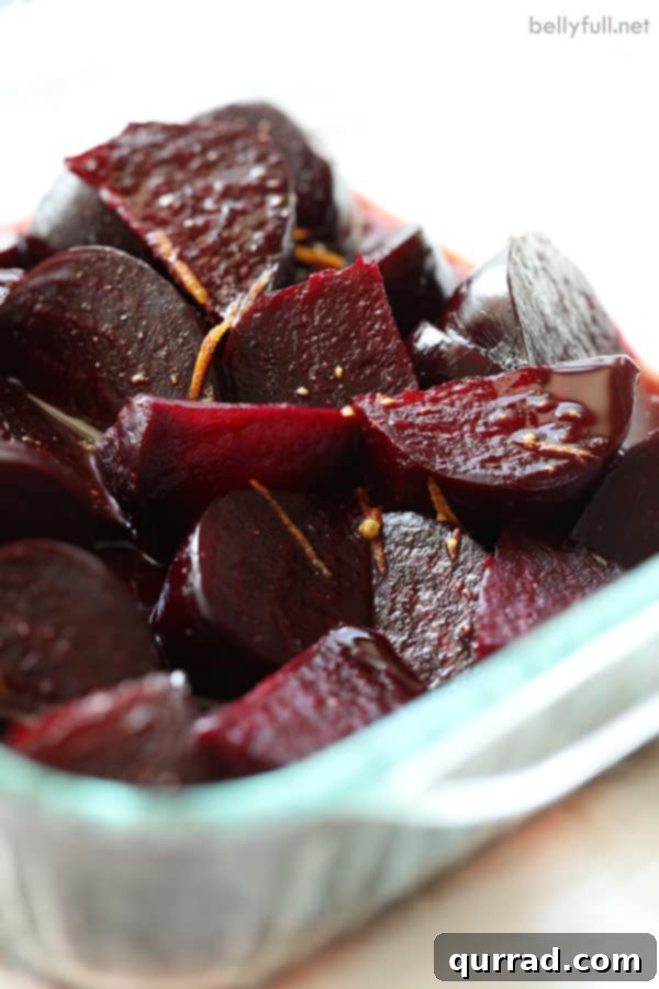 Zesty Maple Roasted Beets 3 Roasted beets with orange and maple glaze glistening in a baking dish, ready to be served.