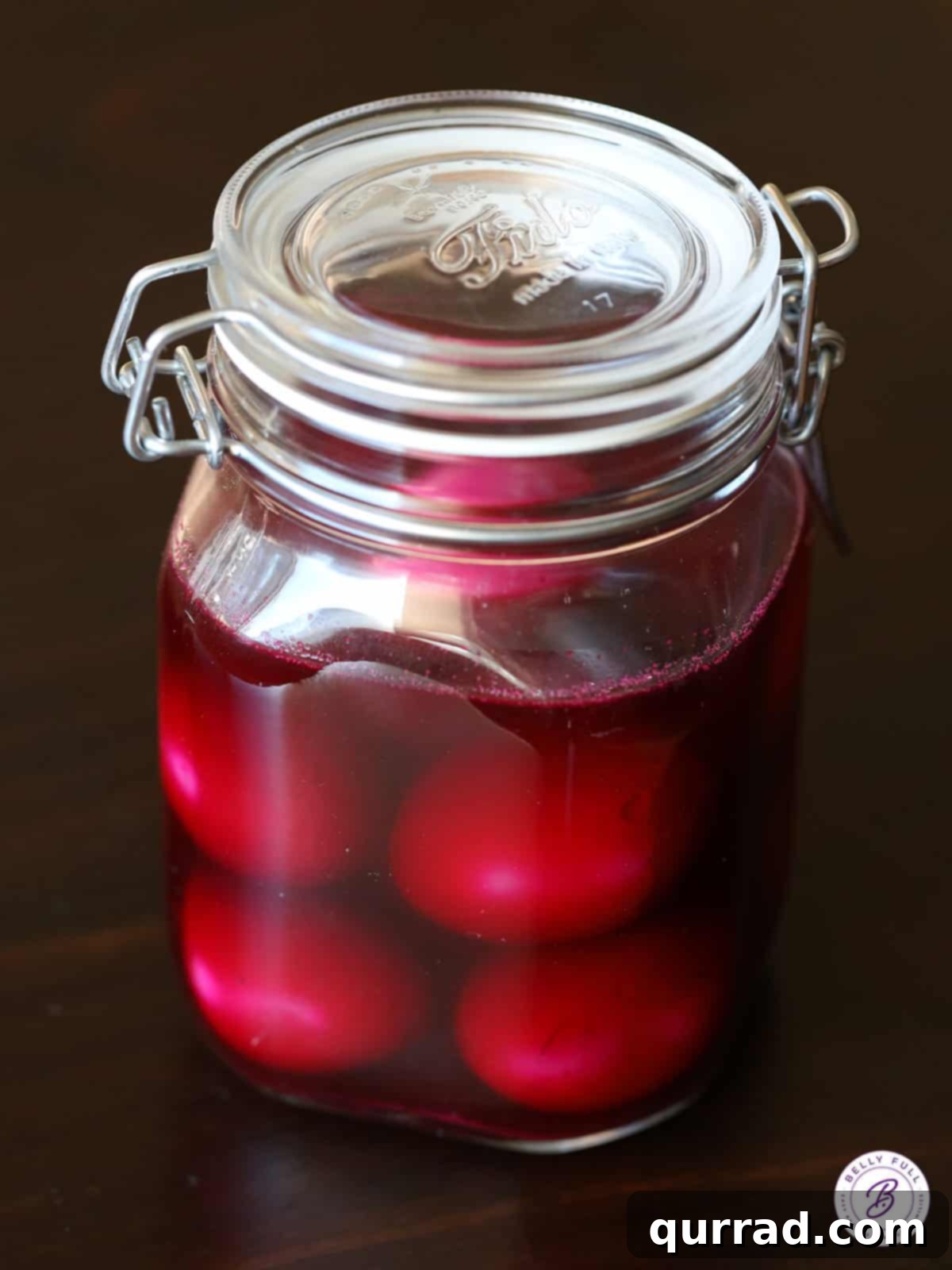 Ruby Red Pickled Eggs 3 glass jar of hard boiled eggs submerged in vibrant beet juice