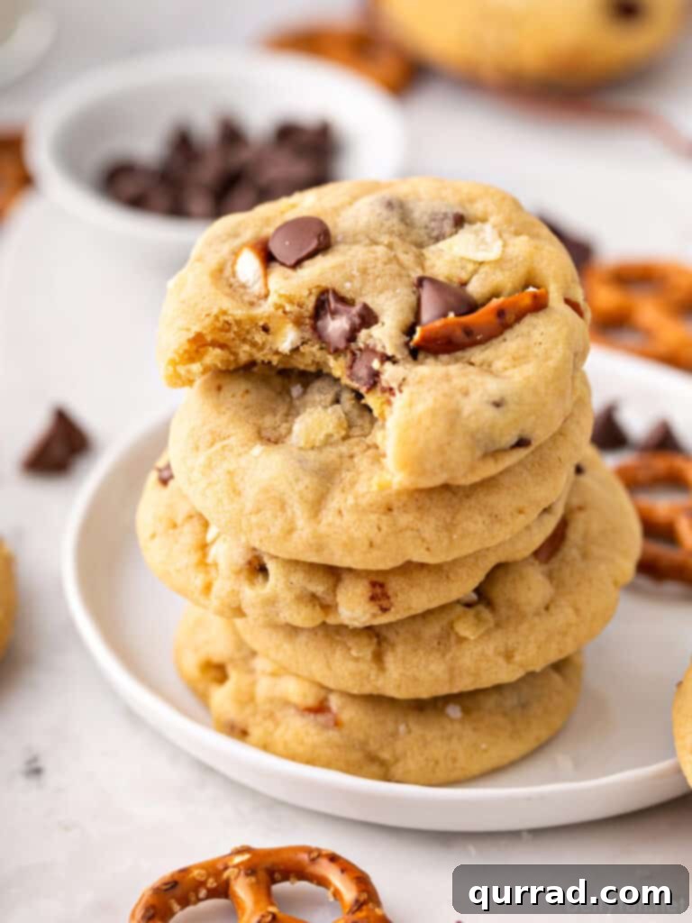 Stack of 5 cookies, top one with a bite taken.