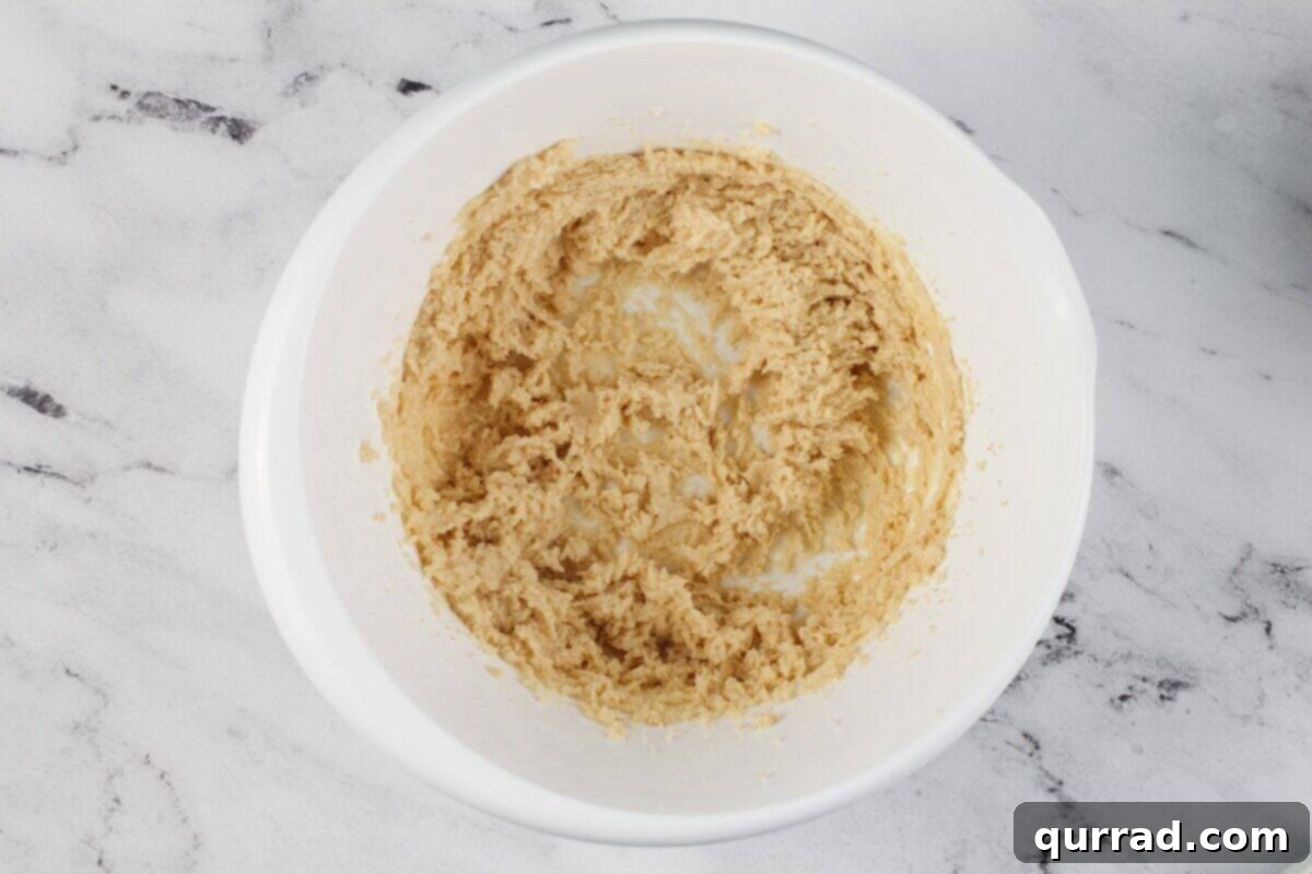 Creaming butter and sugar in a white bowl. 