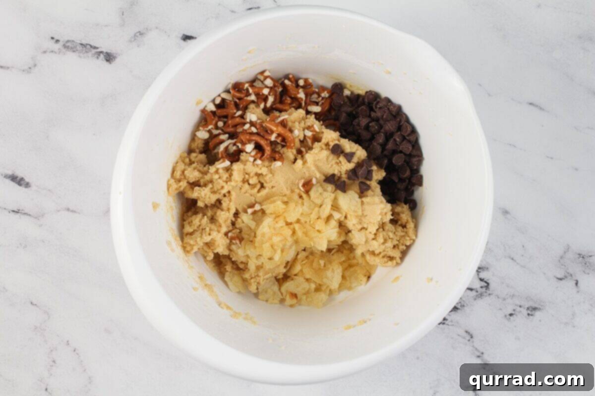 Kitchen sink cookie dough with pretzels, chocolate chips, and potato chips. 