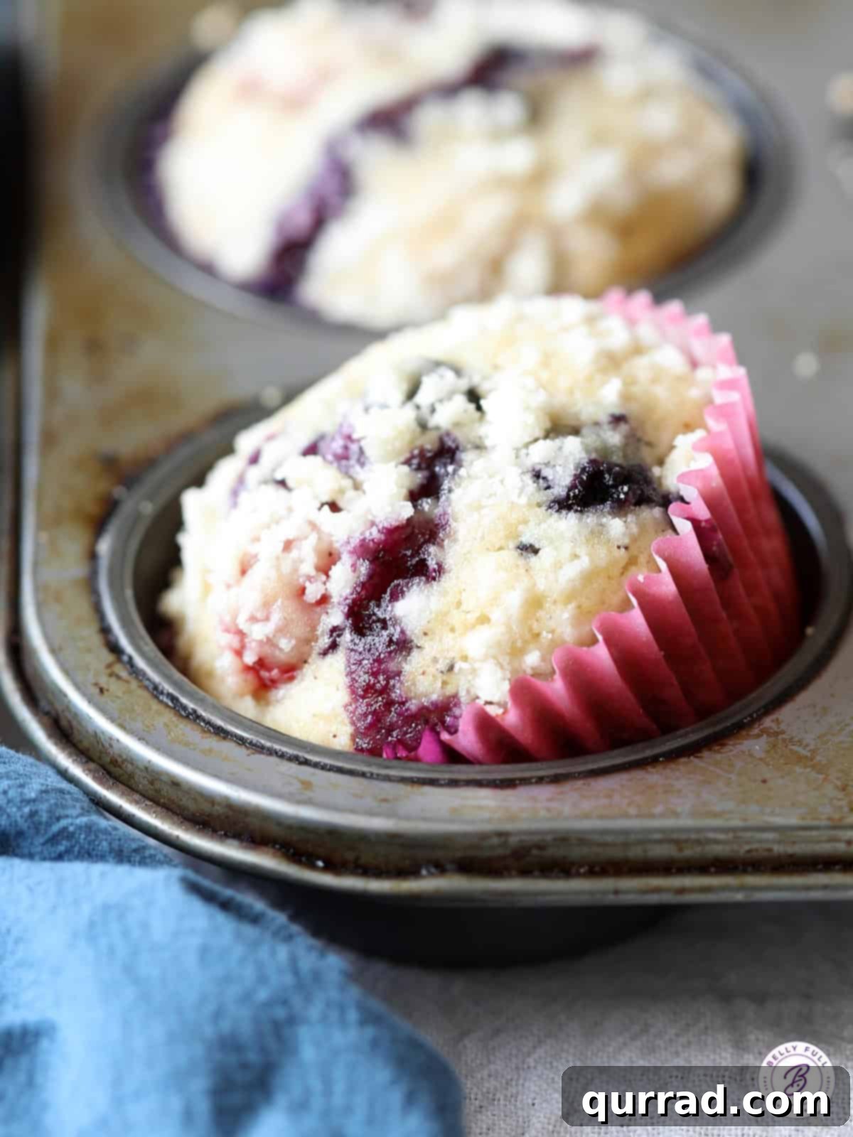 Nutty Brown Butter Berry Muffins 4 berry muffin tilted in muffin tin