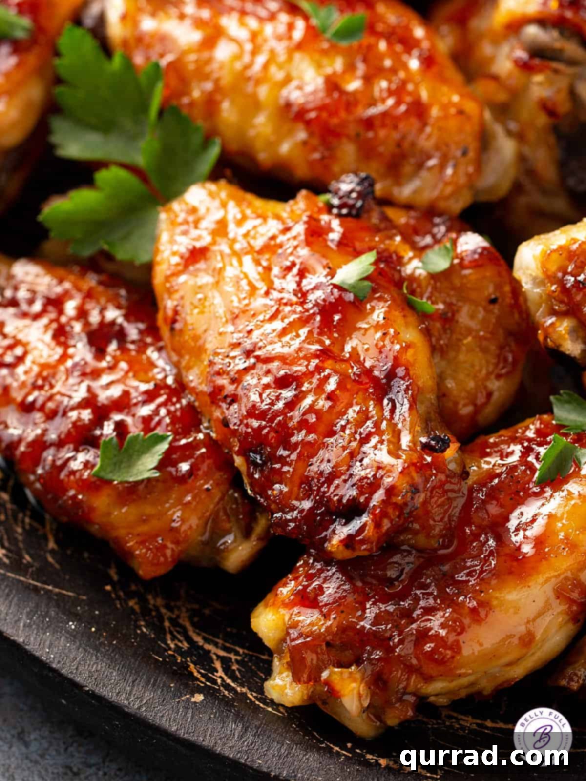 Close-up of golden-brown pineapple-basted baked chicken wings, glistening with glaze