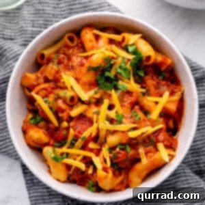 Hearty Weeknight American Goulash 6 bowl of cooked tomato sauce, beef, macaroni, with shredded cheddar