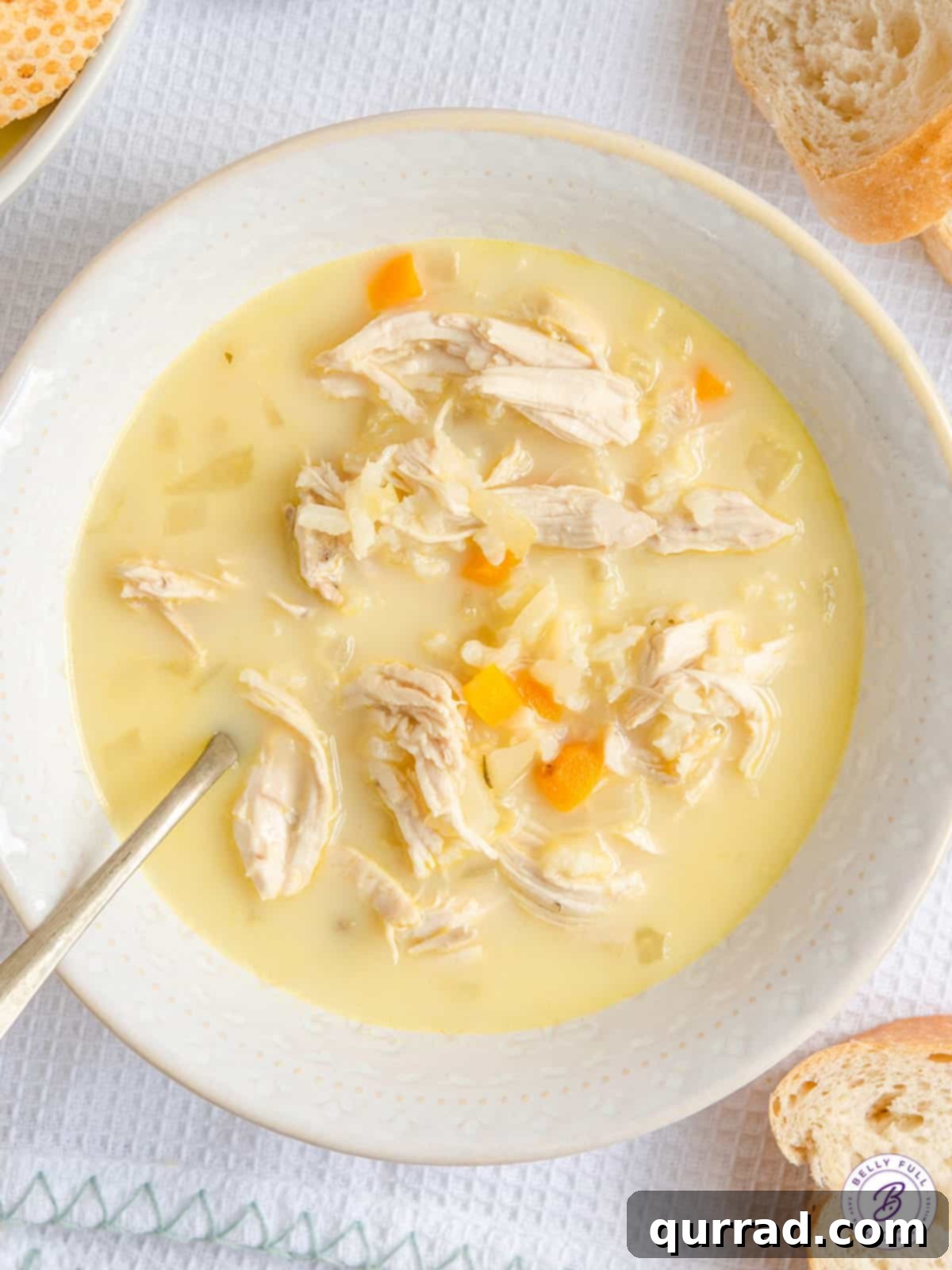 Golden Avgolemono Greek Lemon Chicken Soup 9 A beautifully presented bowl of Avgolemono Soup, garnished with fresh dill.