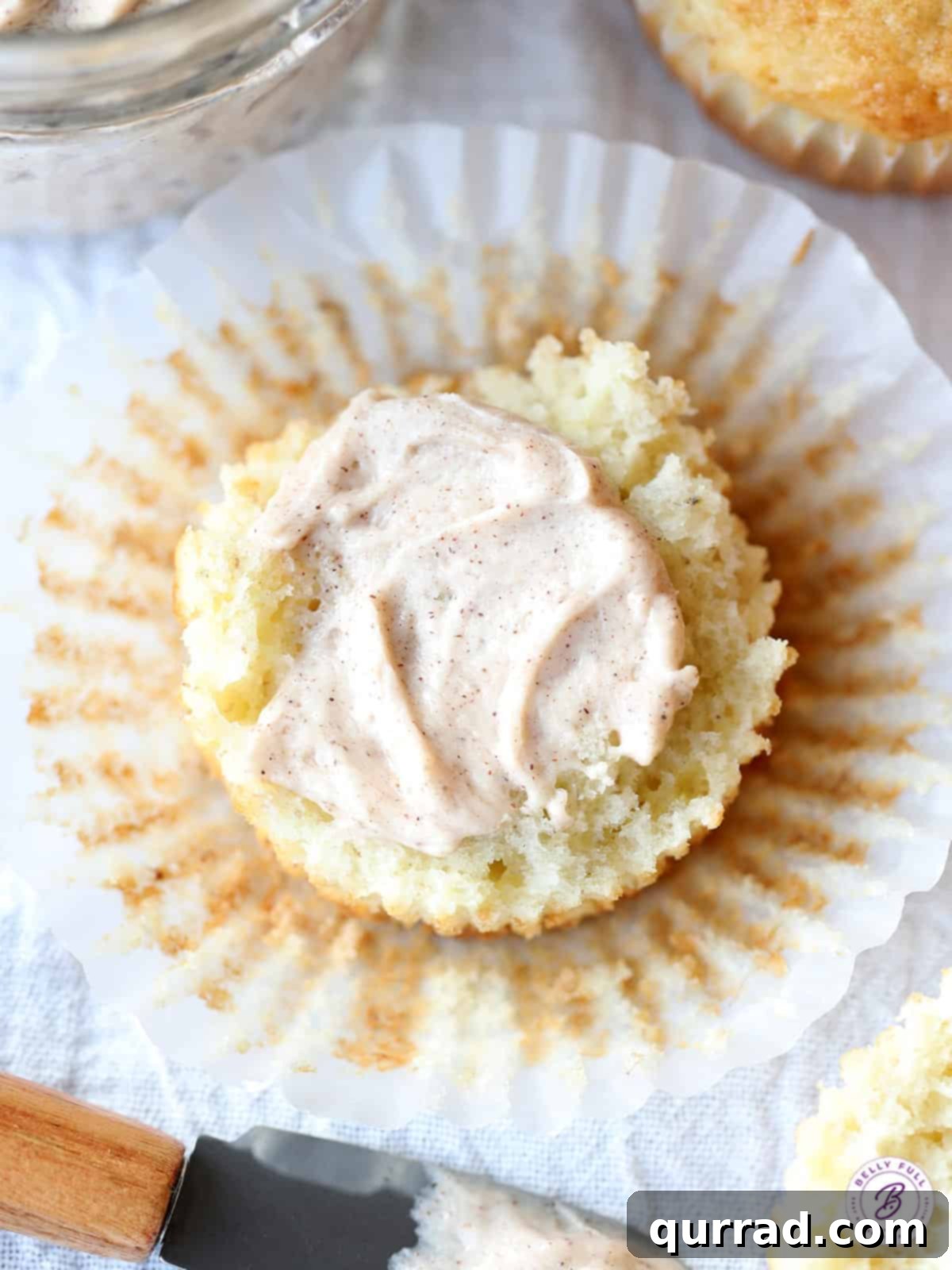 Sweet Cinnamon Butter 5 overhead muffin split in half with cinnamon flavored whipped butter
