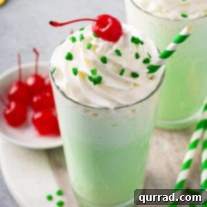 Homemade McDonalds Shamrock Shake 3 Close-up of a Shamrock Shake topped with whipped cream, sprinkles, and a cherry