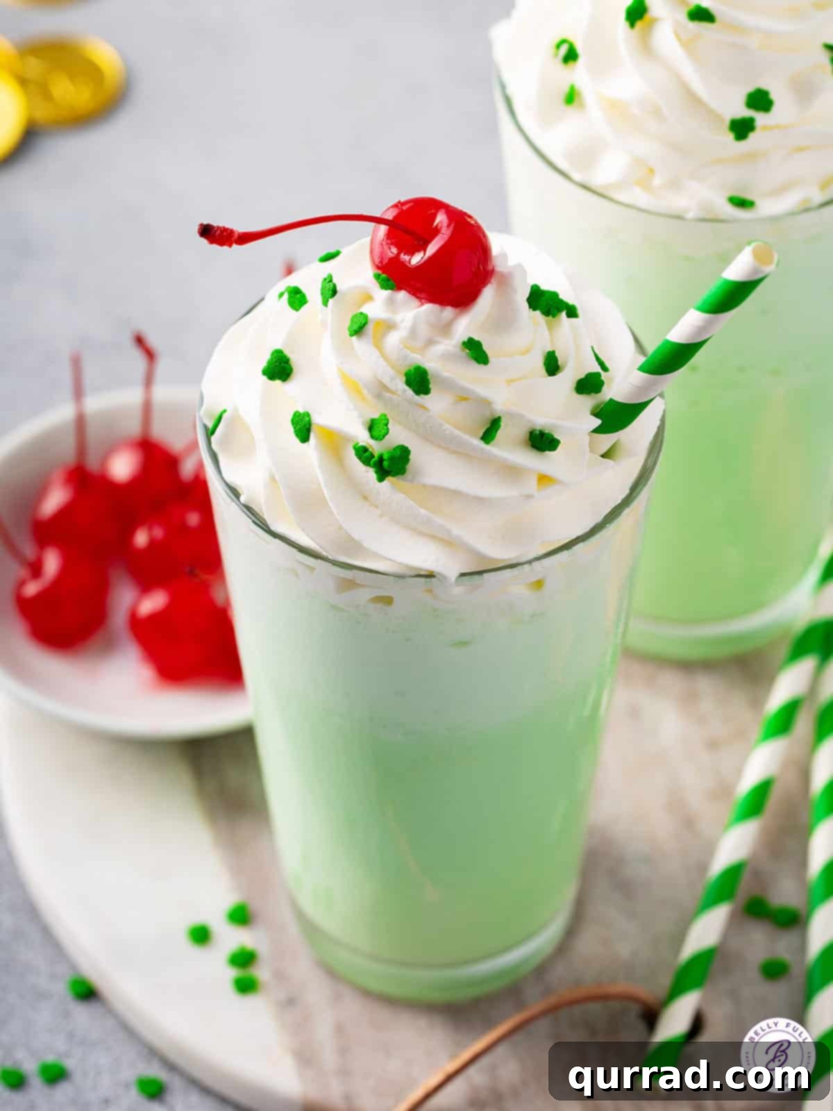 Homemade McDonalds Shamrock Shake 4 Two Shamrock Shakes in tall glasses, one with a straw and cherry, the other plain