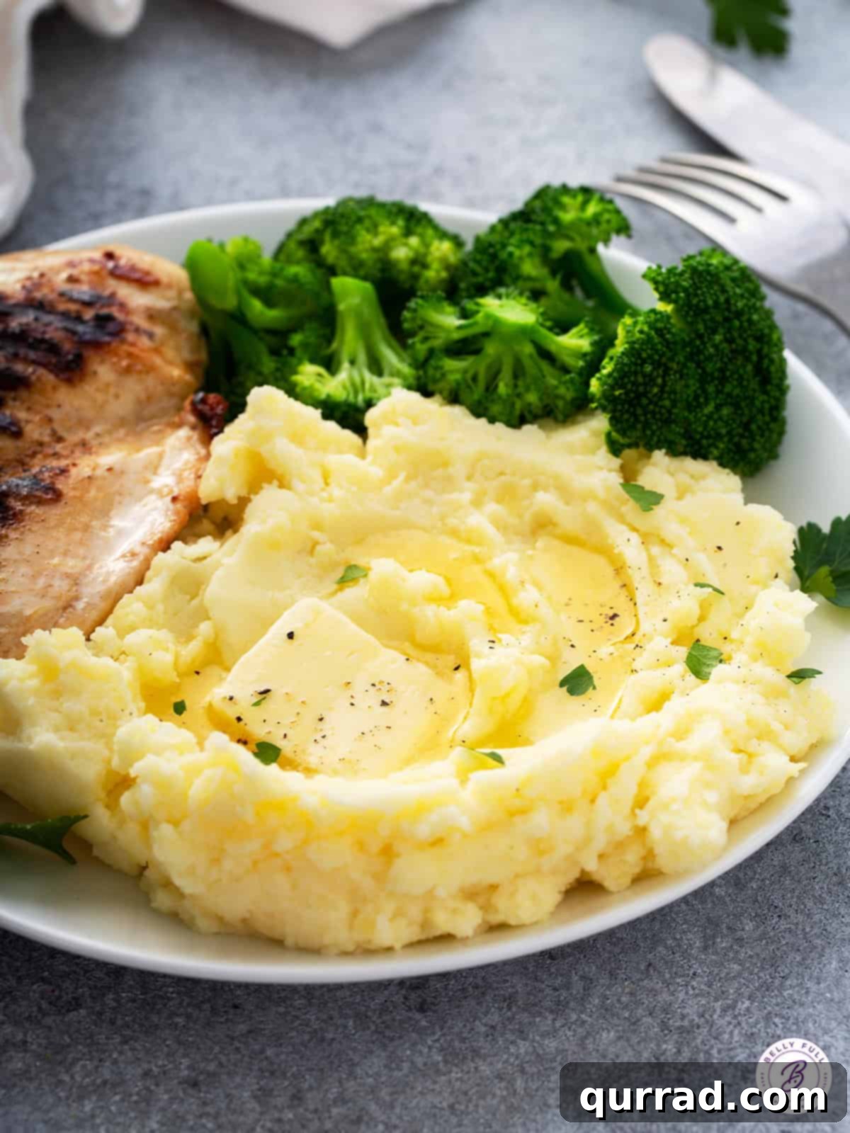 Melt-in-Your-Mouth Mashed Potatoes 5 creamy mashed potatoes with melted butter on plate, ready to be enjoyed