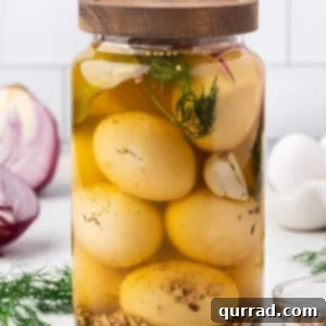A tightly sealed jar of golden pickled eggs, garnished with fresh dill and red onion slices.