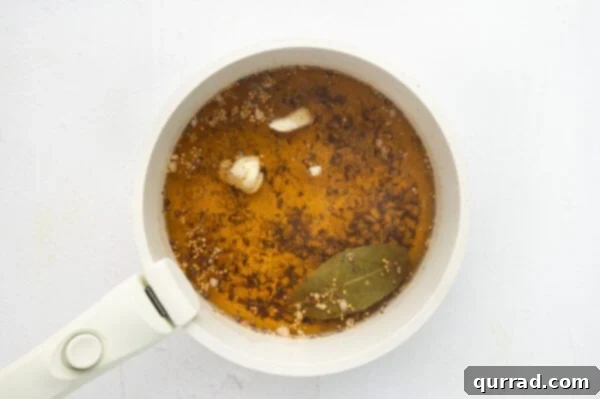 A saucepan filled with a simmering vinegar brine, ready to be cooled.