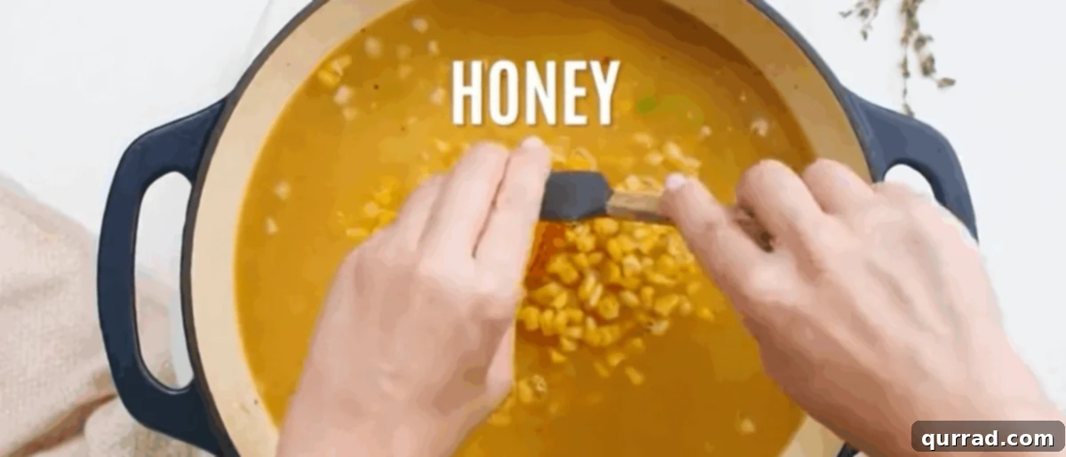 Creamy Golden Corn Chowder 8 Adding chicken broth, diced potatoes, corn, honey, thyme, and bay leaves to the pot.