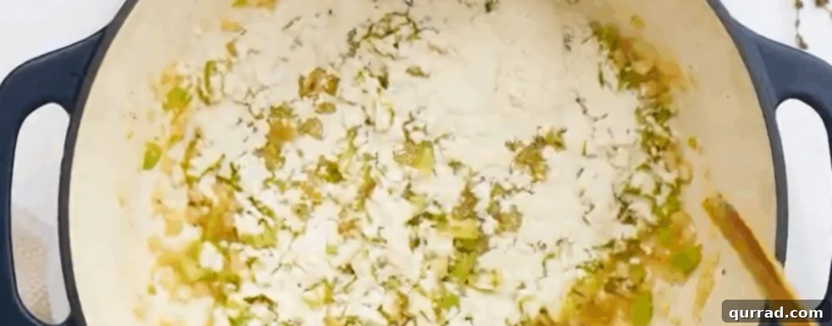 Creamy Golden Corn Chowder 7 Sprinkling all-purpose flour into the pot with sautéed vegetables to create a roux.