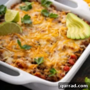 uncut Mexican Lasagna in white baking dish, top view