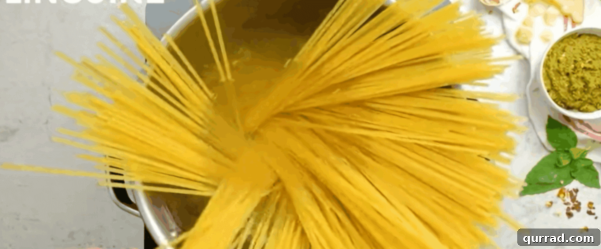 Zesty Shrimp Pesto Pasta 4 Pasta cooking in a pot of boiling water.