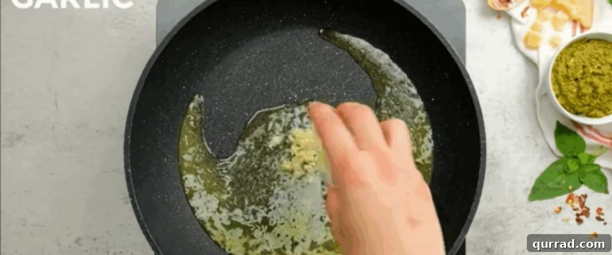 Zesty Shrimp Pesto Pasta 5 Cooking minced garlic in melted butter in a skillet.