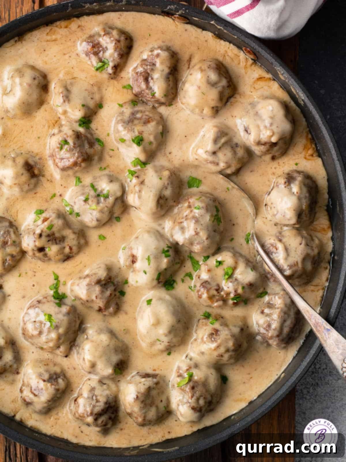 Creamy Swedish Meatballs 2 A skillet filled with homemade Swedish Meatballs generously coated in a rich brown gravy, ready to be served.