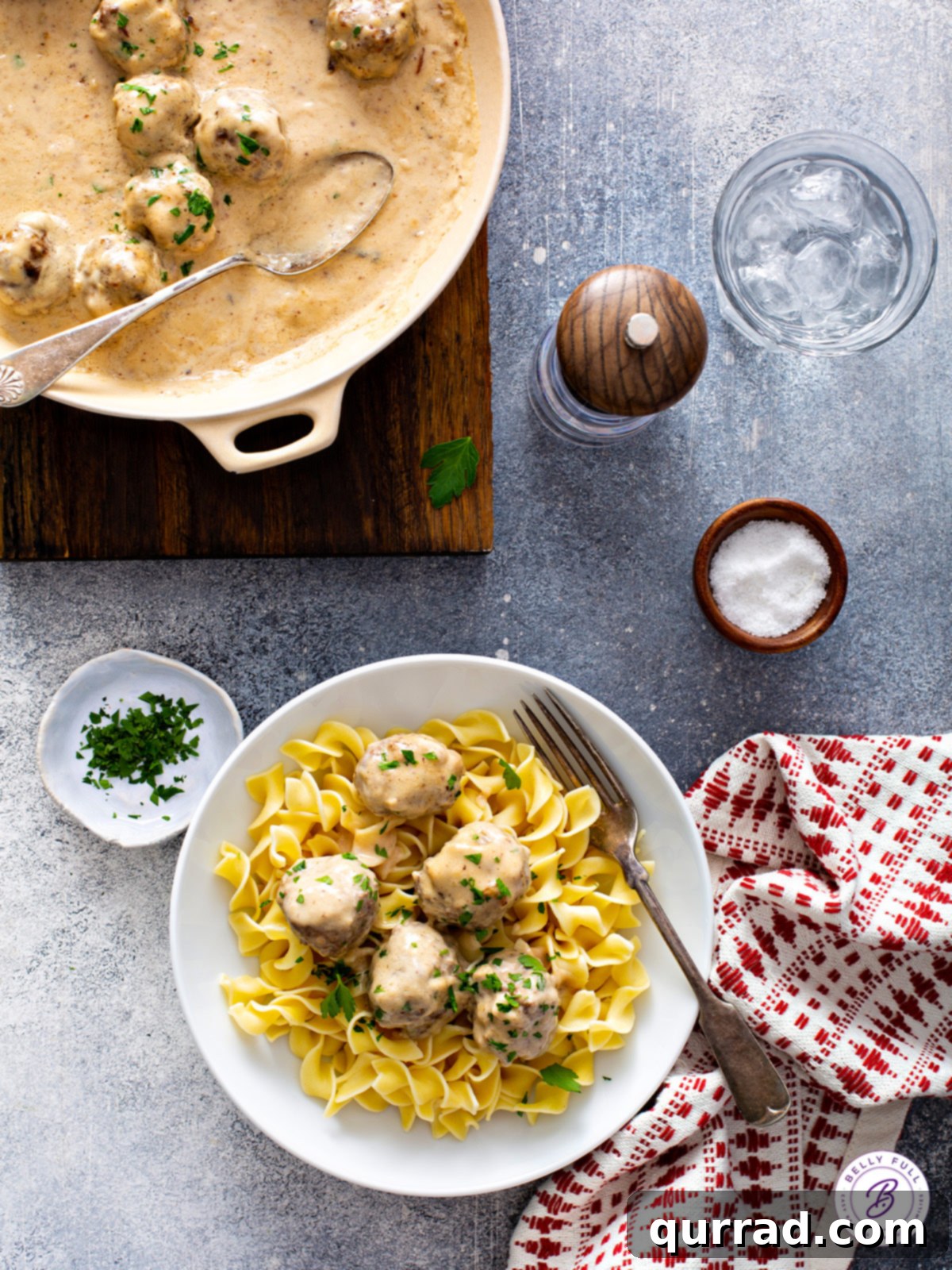 Creamy Swedish Meatballs 4 A bowl of Swedish Meatballs and egg noodles generously coated in gravy, with a fork ready to enjoy.