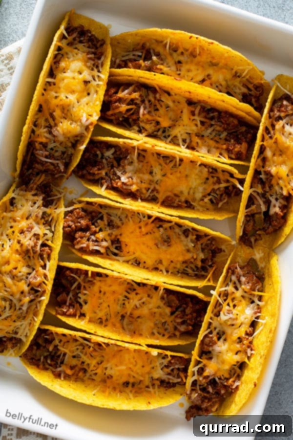 overhead of baked tacos with melted cheese in casserole dish
