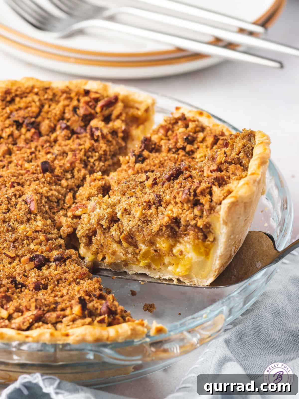 Velvet Peach Pecan Pie 8 Slice of peach pie on serving spatula.