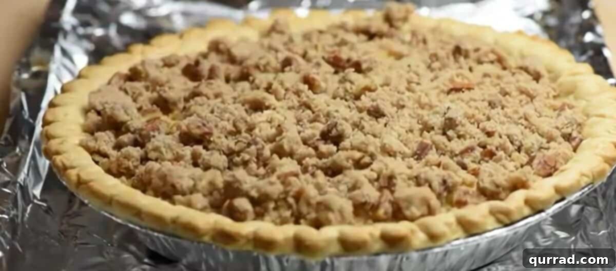 Velvet Peach Pecan Pie 6 Streusel topping on top of the pie.