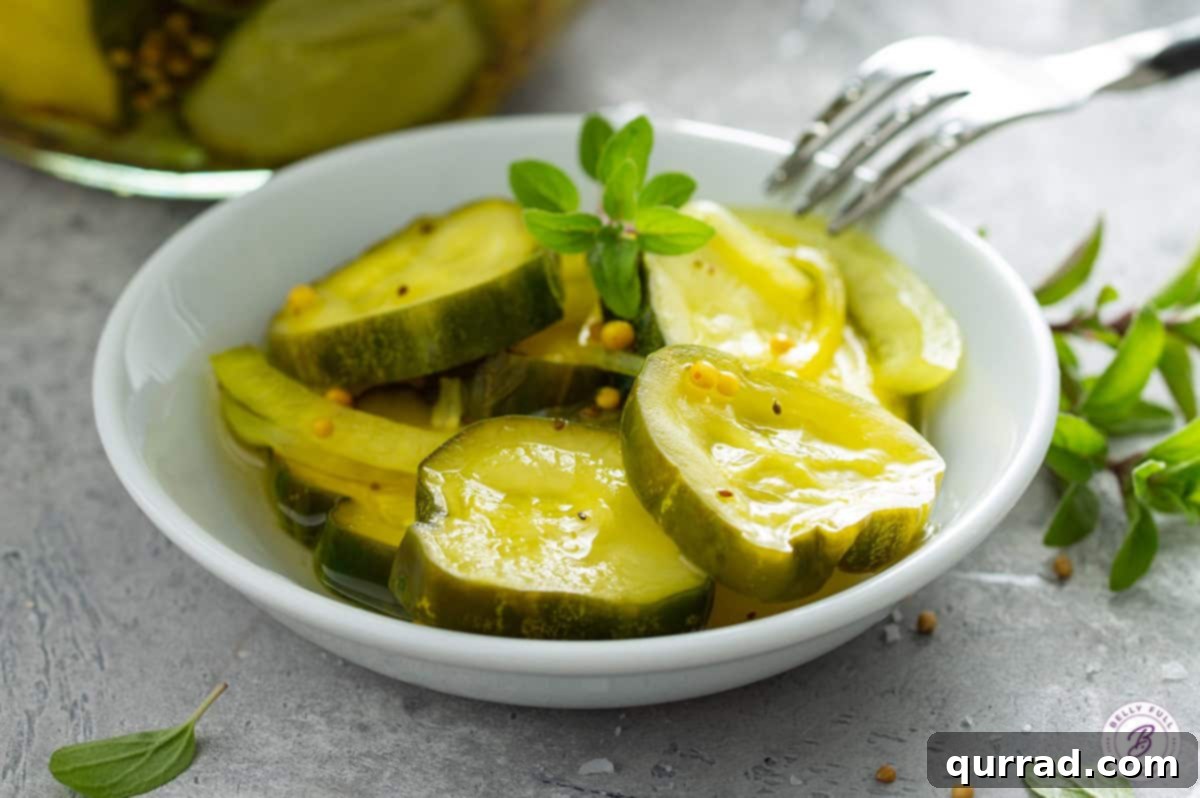 Crisp Sweet and Zesty Cucumber Pickles 4 bread and butter pickle slices on plate with fork