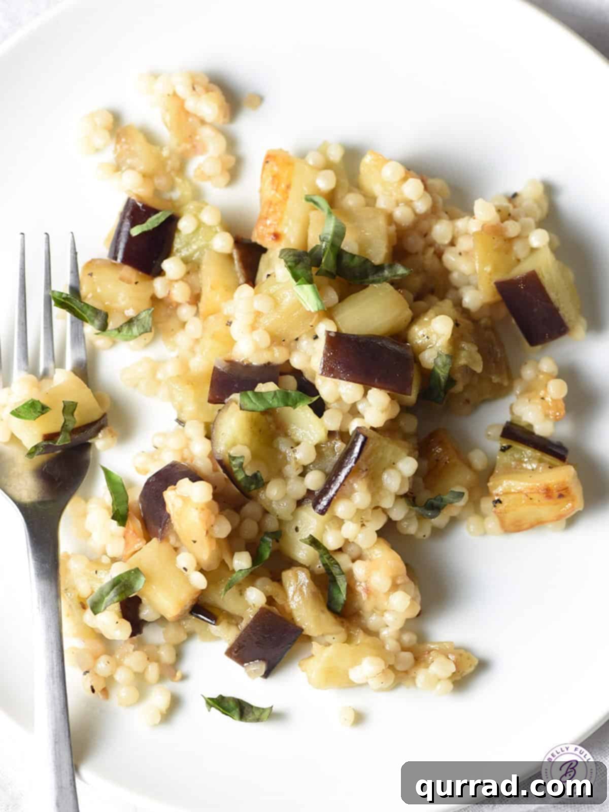 Mediterranean Eggplant Couscous 4 Overhead view of pearl couscous side dish with eggplant and fresh basil
