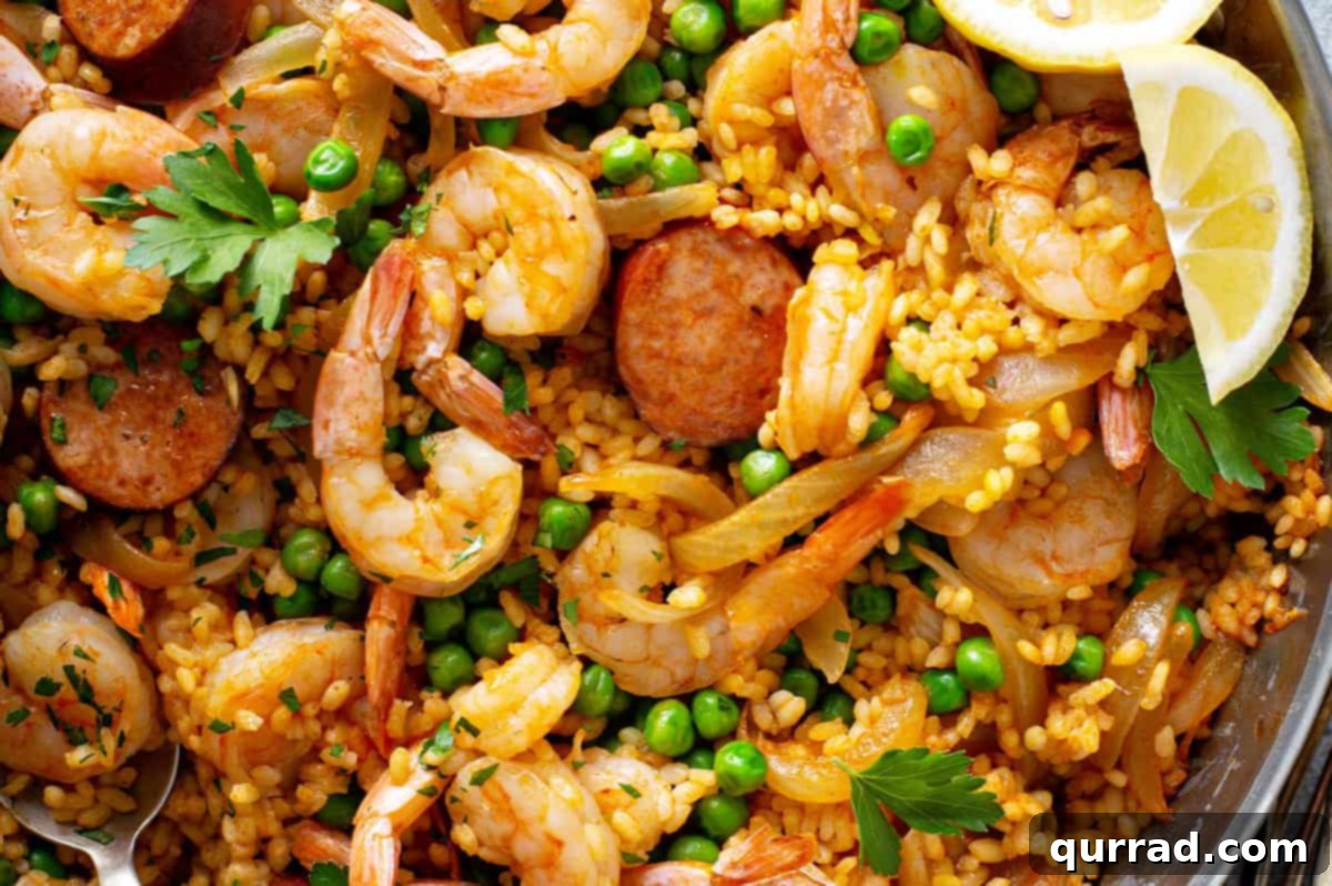 Simplified Weeknight Paella 8 Fresh shrimp carefully nestled on top of the simmering rice in the paella pan, cooking to a perfect pink hue as the liquid absorbs.