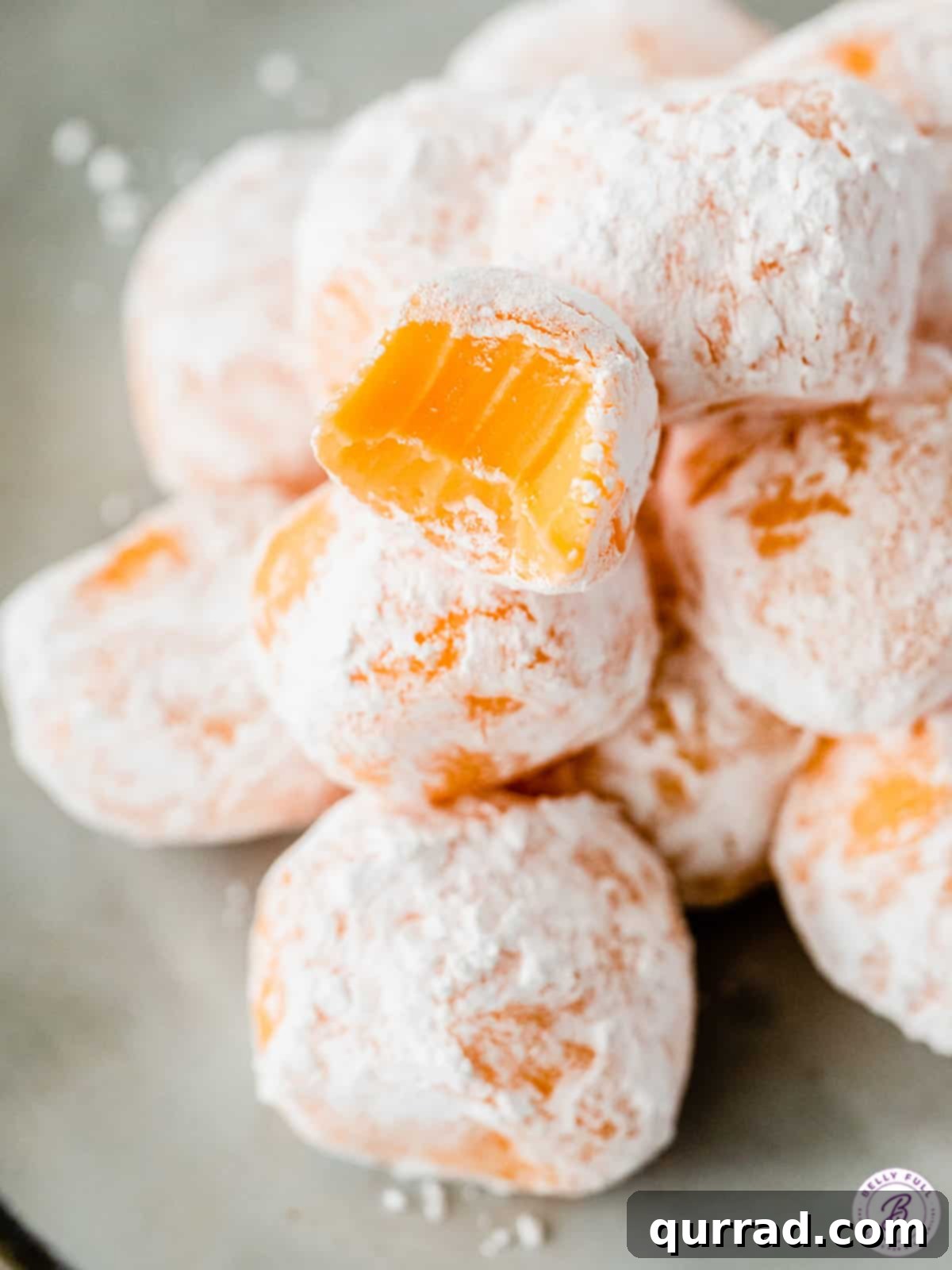 Luscious Orange Creamsicle Truffles 4 orange chocolate truffle coated in powdered sugar with a bite