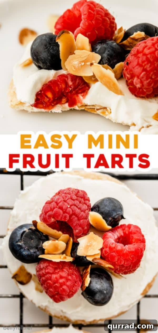 Pinterest pin image for Berries and Cream Mini Fruit Tarts recipe, featuring an arrangement of tarts with fresh berries and almonds.