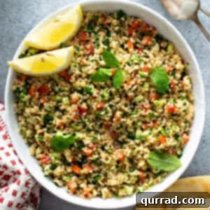 overhead bowl of Tabbouleh with lemon wedges