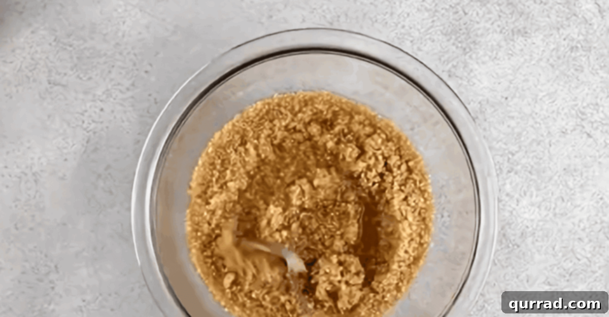 Bulgur soaking in water in a glass bowl.